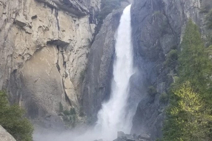 a waterfall with a mountain in the background